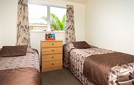 two single beds in the second bedroom of 2-bedroom unit
